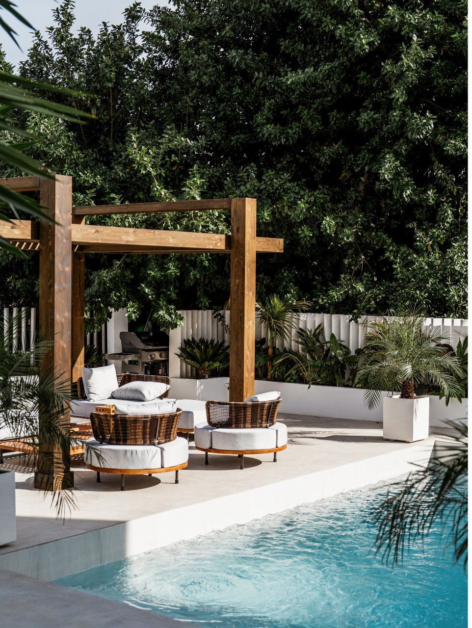 Modern outdoor patio with wooden pergola and comfortable seating